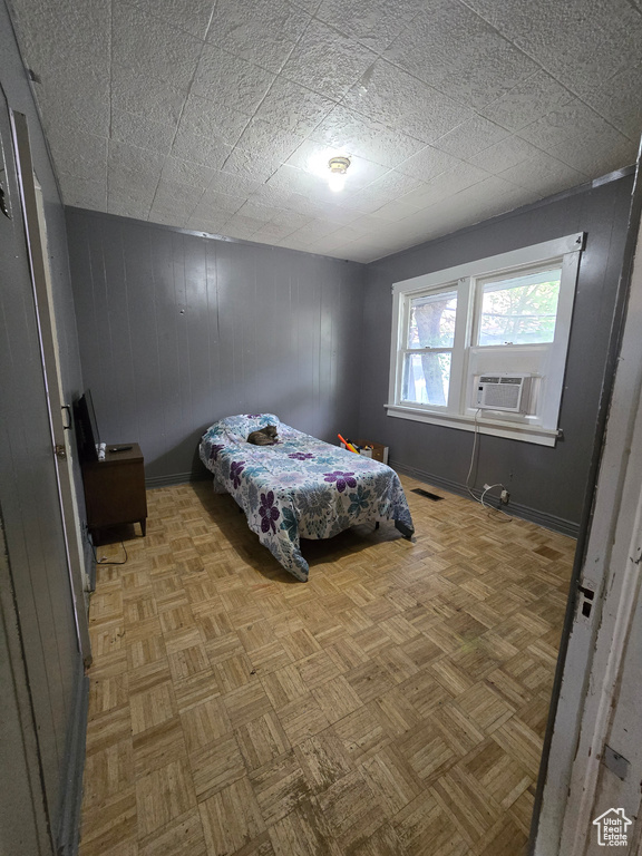 Unfurnished bedroom with parquet floors