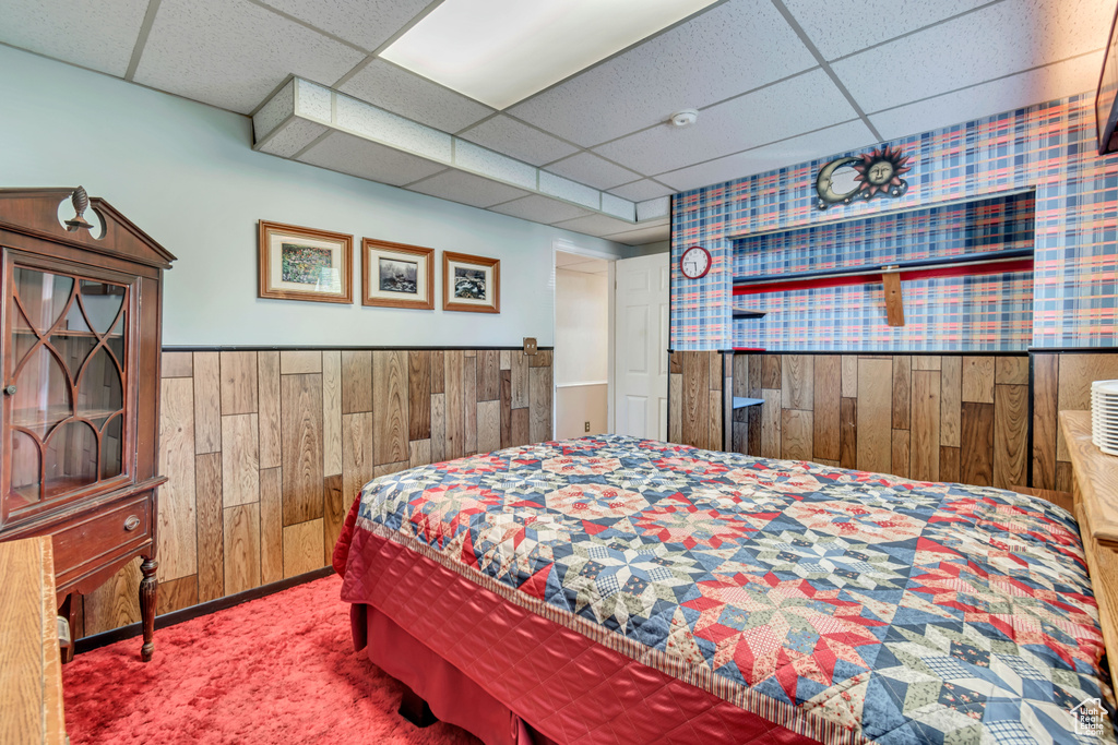 Carpeted bedroom with a paneled ceiling