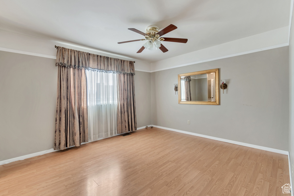 Spare room featuring light hardwood / wood-style floors and ceiling fan