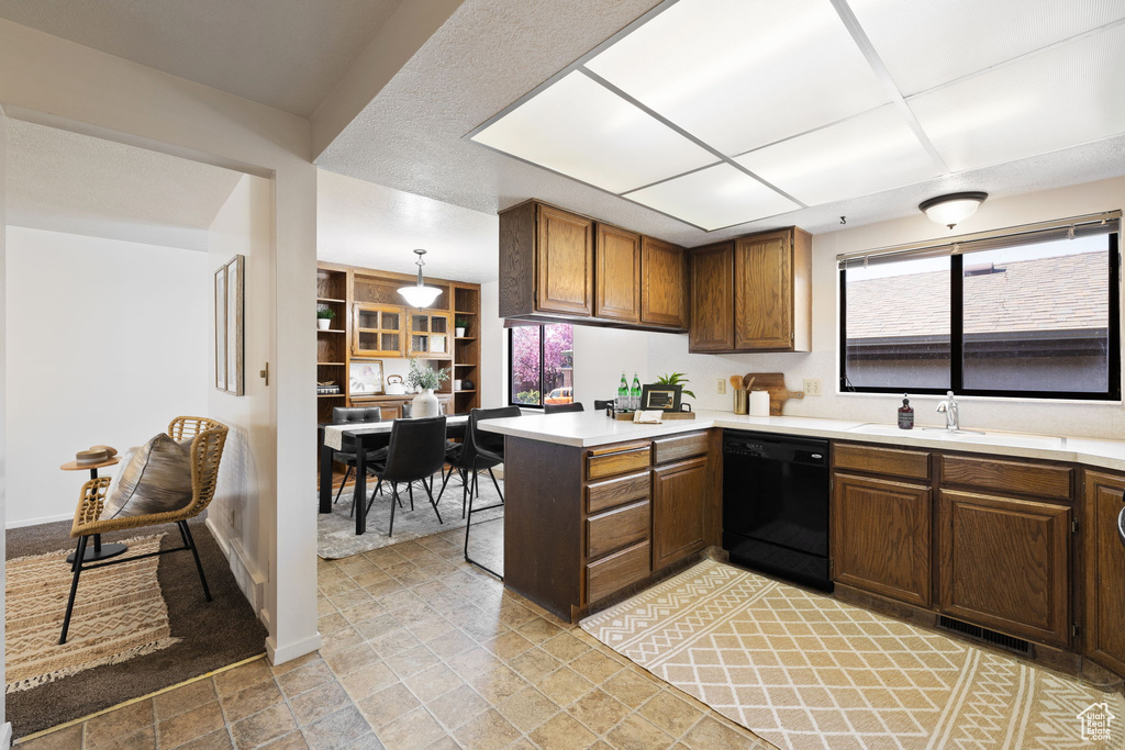 Kitchen with sink, dishwasher, light tile floors, and plenty of natural light