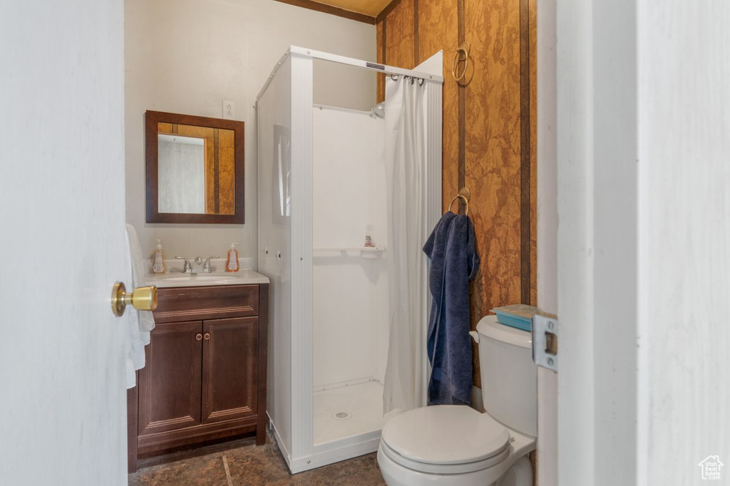Bathroom with curtained shower, toilet, tile flooring, and oversized vanity
