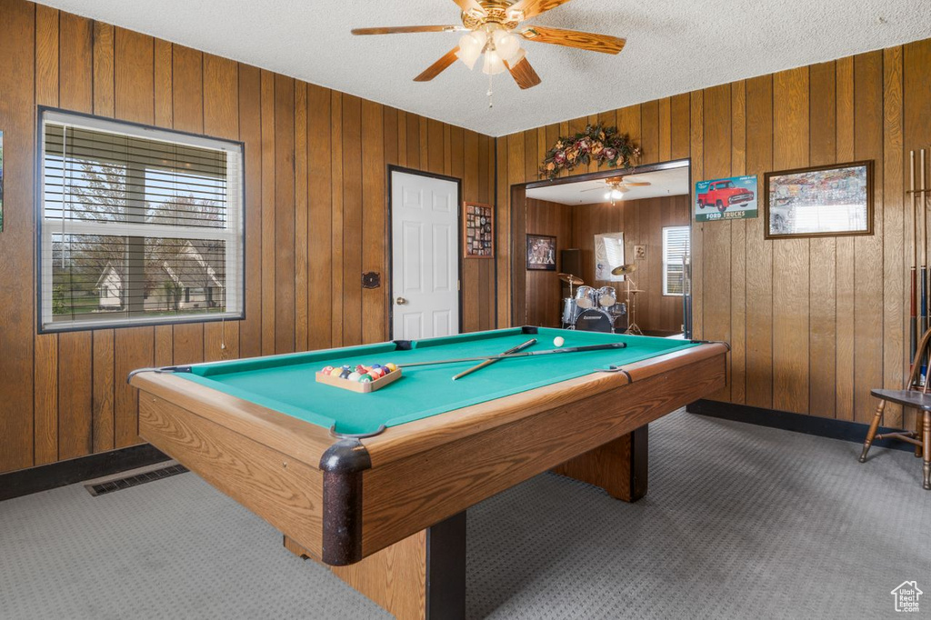 Playroom with wood walls, pool table, and dark colored carpet