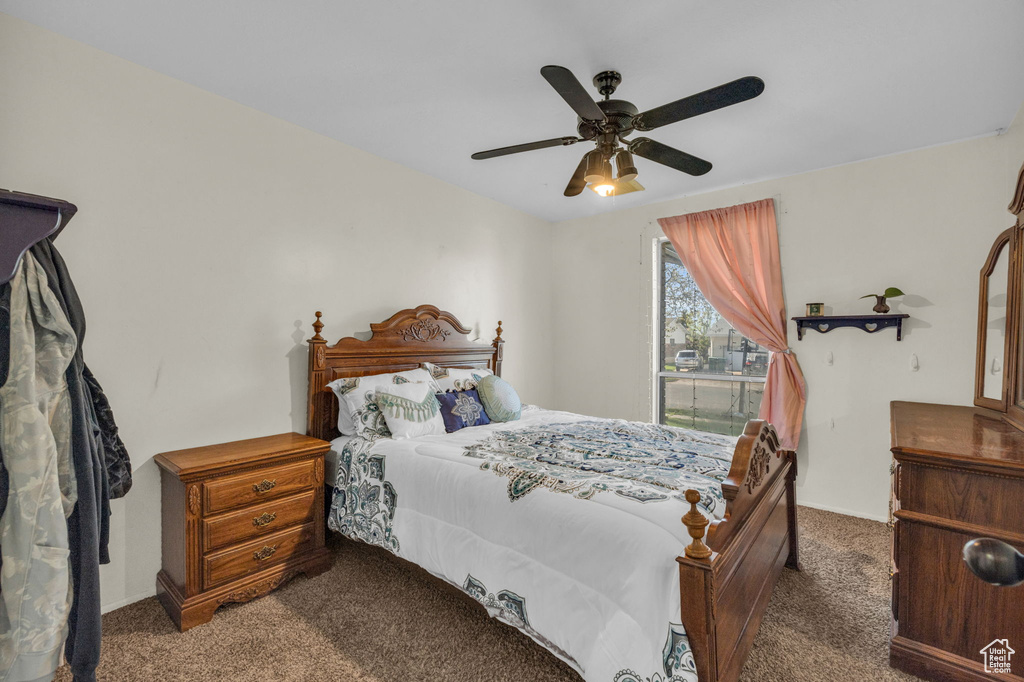 Bedroom featuring ceiling fan and carpet flooring