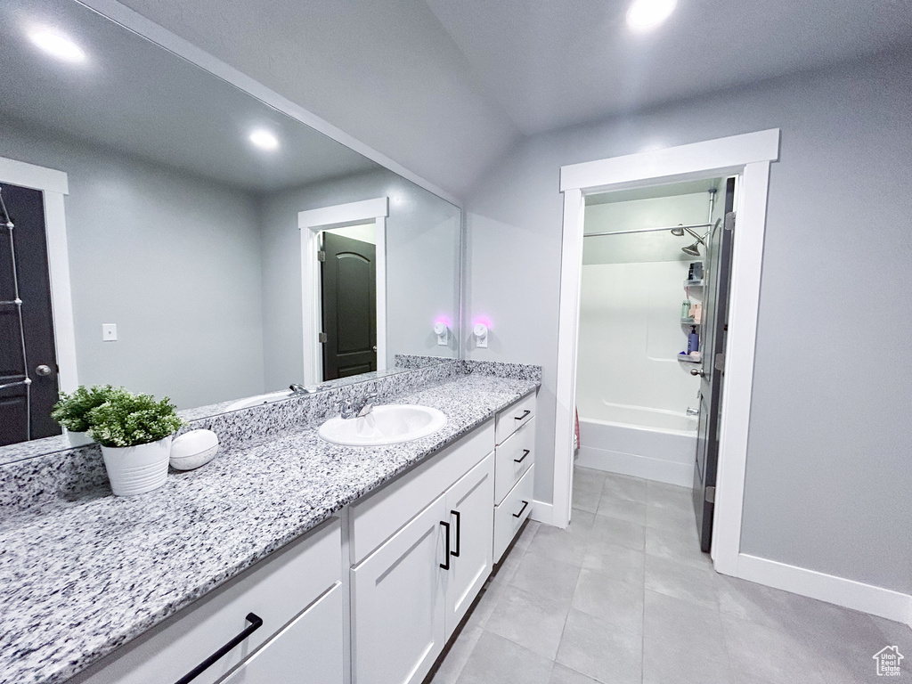 Bathroom featuring shower / bathtub combination, oversized vanity, and tile floors