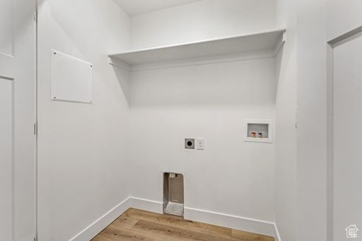 Washroom featuring hardwood / wood-style floors, hookup for a washing machine, and electric dryer hookup