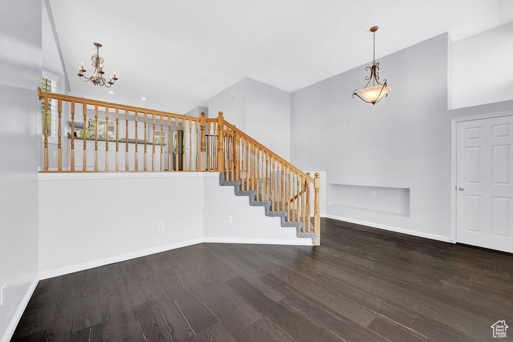 Foyer entrance featuring dark hardwood / wood-style flooring and a chandelier