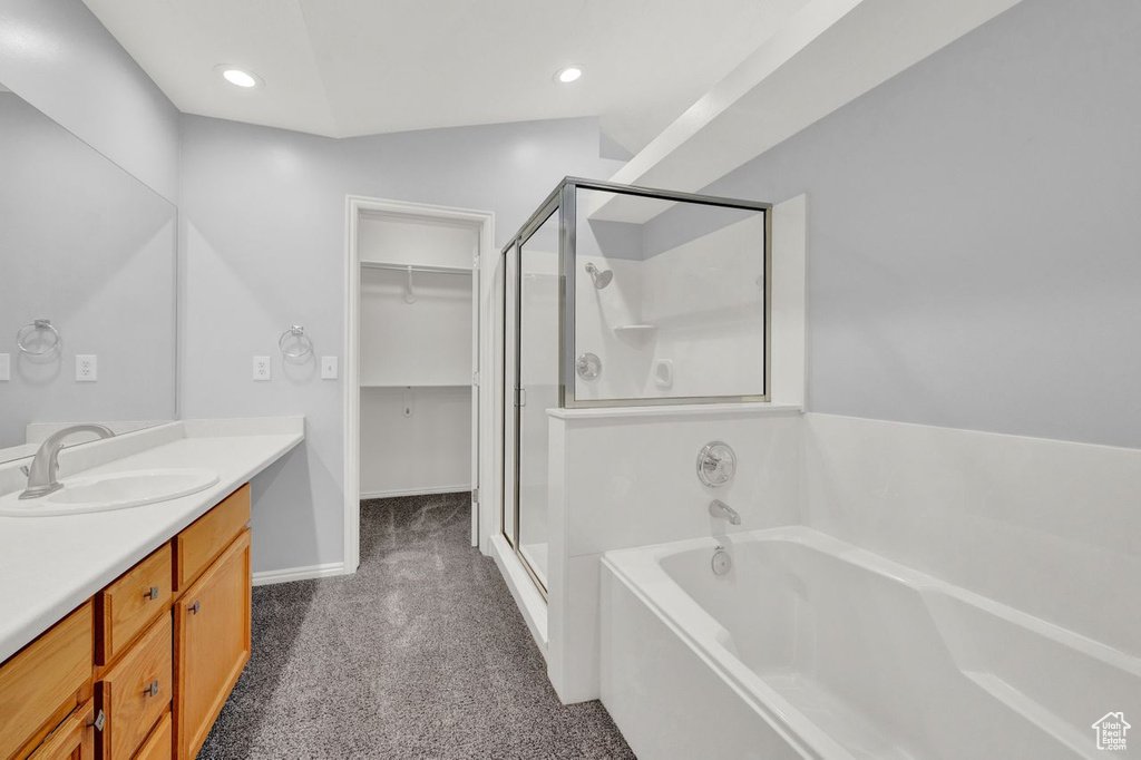 Bathroom with vanity and plus walk in shower