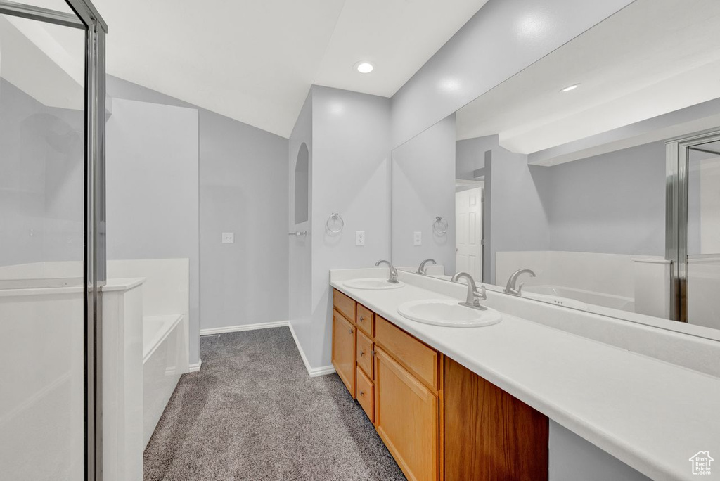 Bathroom featuring double vanity and plus walk in shower