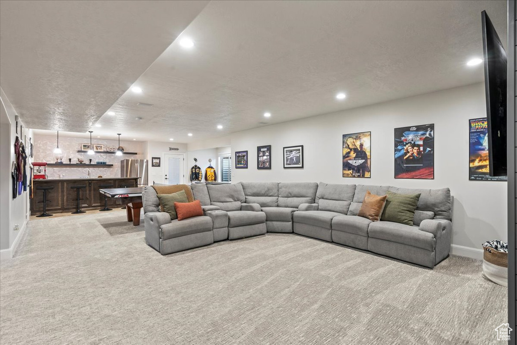 Carpeted living room with bar area