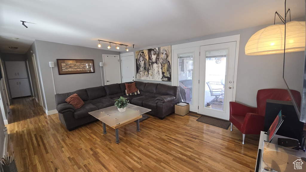 Living room featuring rail lighting and hardwood / wood-style floors