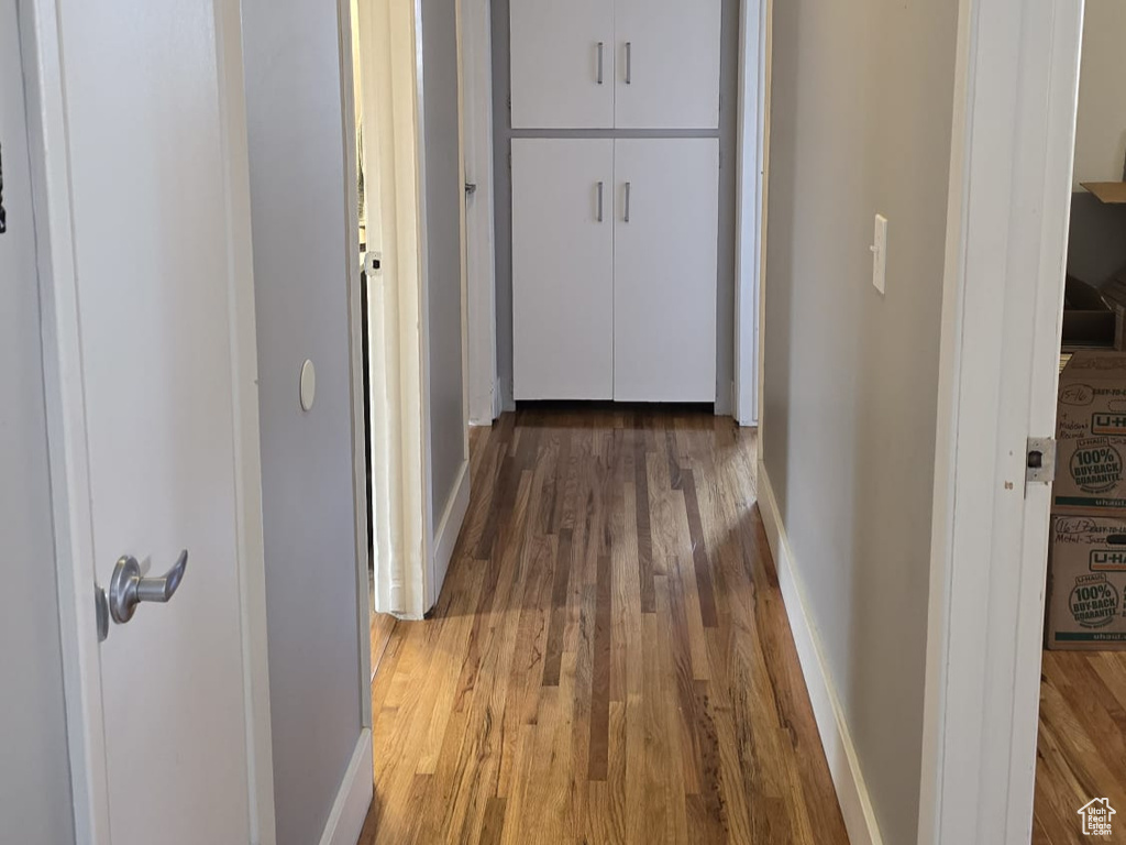 Hall with hardwood / wood-style flooring