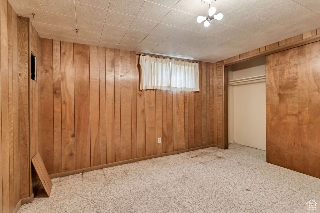 Basement with wood walls and tile floors