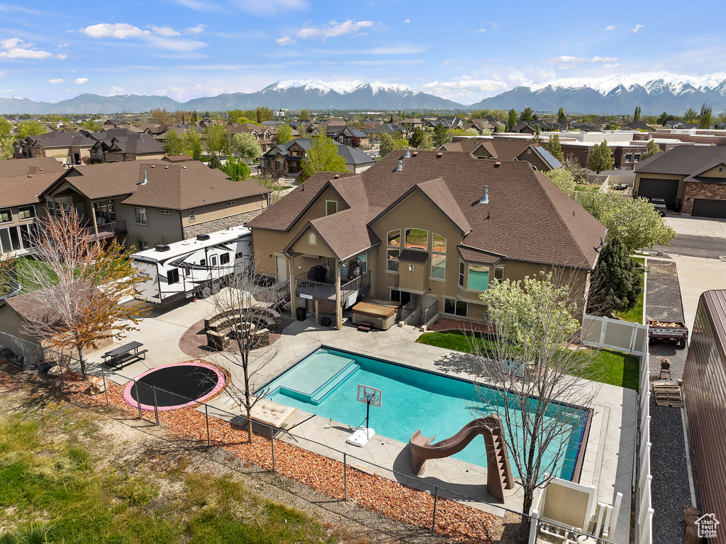 View of swimming pool with a patio and a mountain view