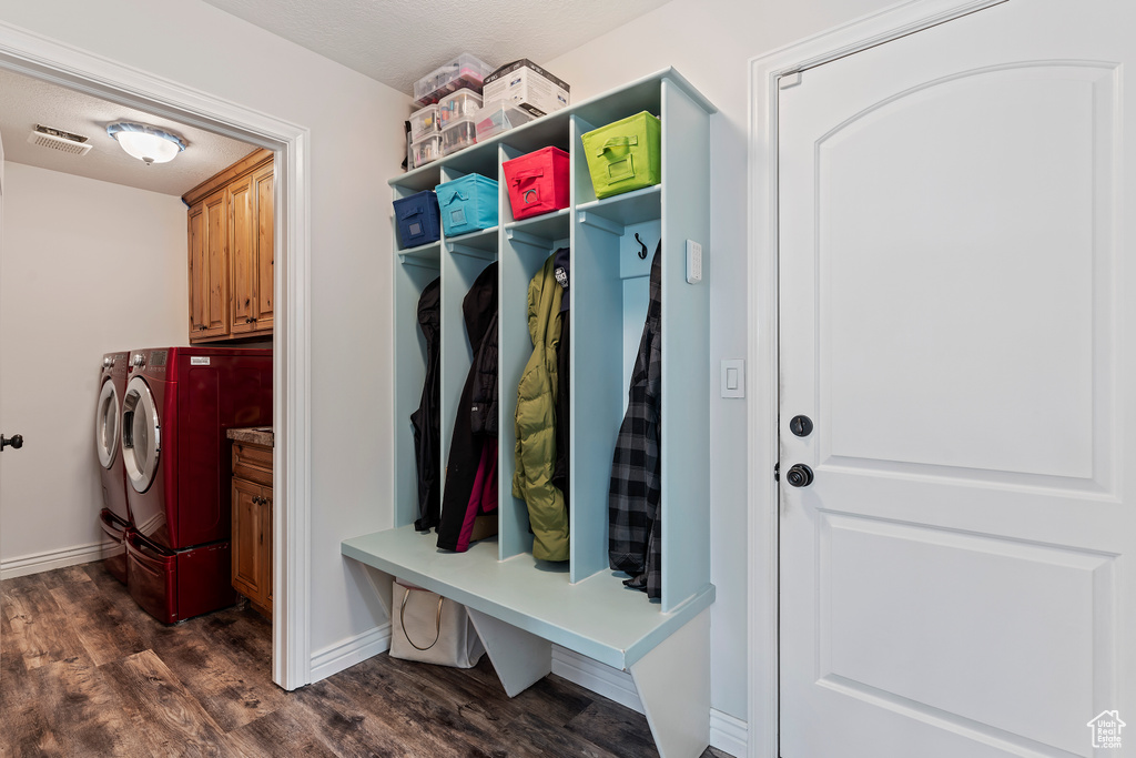 Mudroom featuring dark hardwood / wood-style flooring and washer and clothes dryer