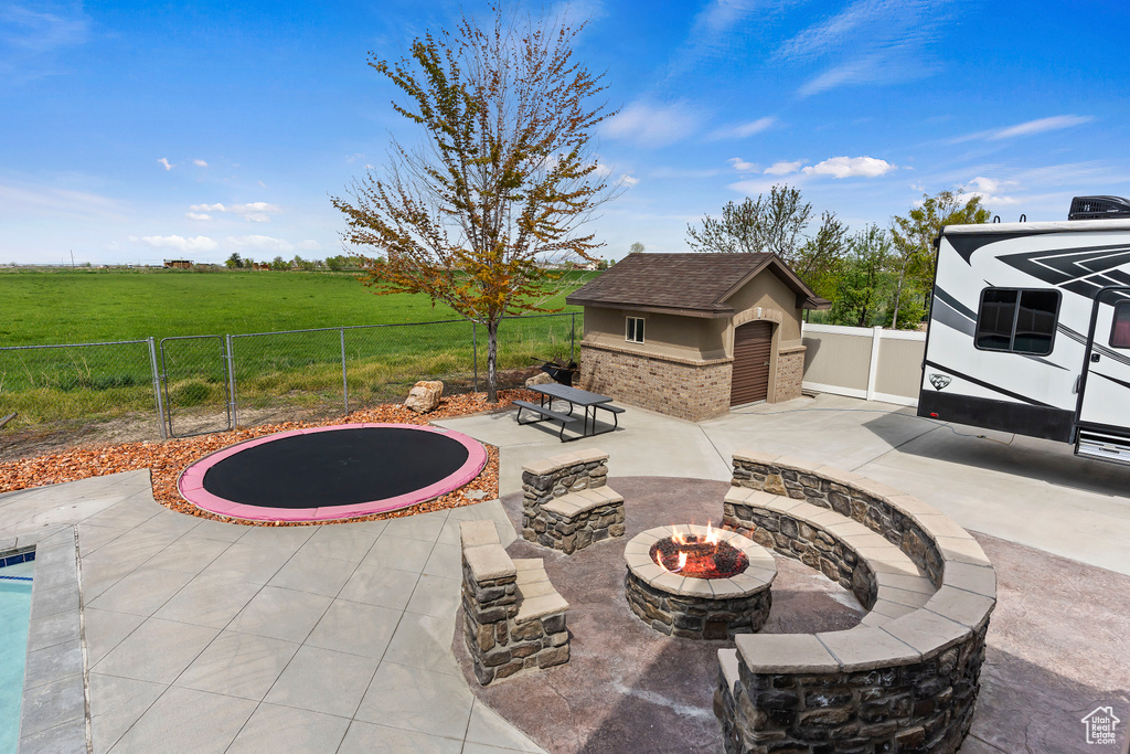 View of patio featuring a fire pit