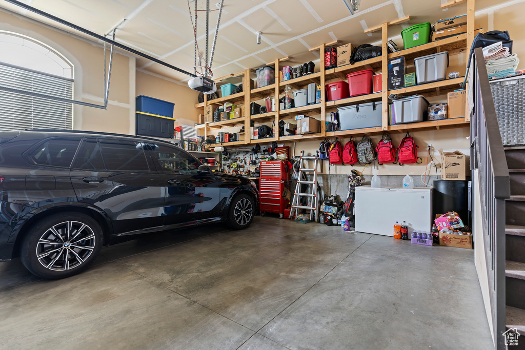 Garage featuring a workshop area and a garage door opener