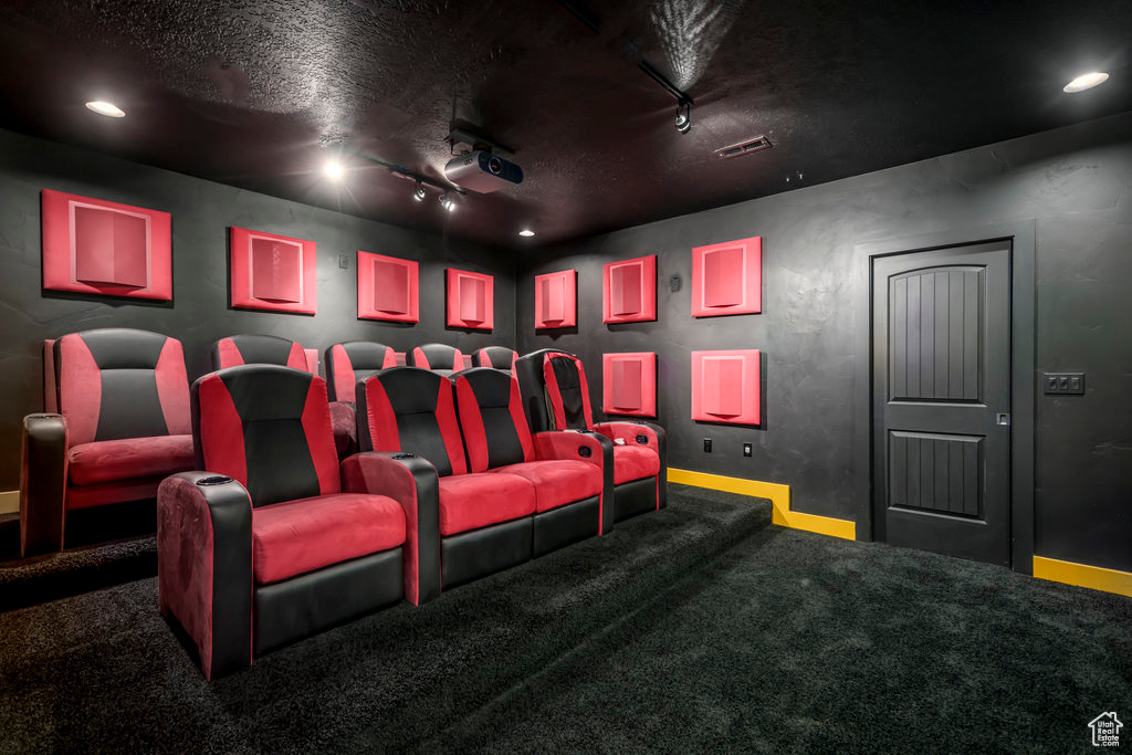 Cinema featuring track lighting and dark colored carpet