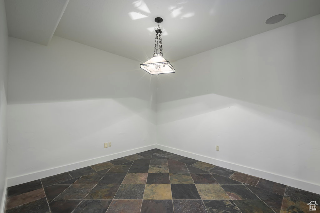 Unfurnished room with dark tile floors