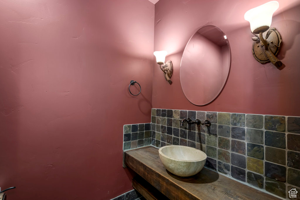 Bathroom with tasteful backsplash and vanity