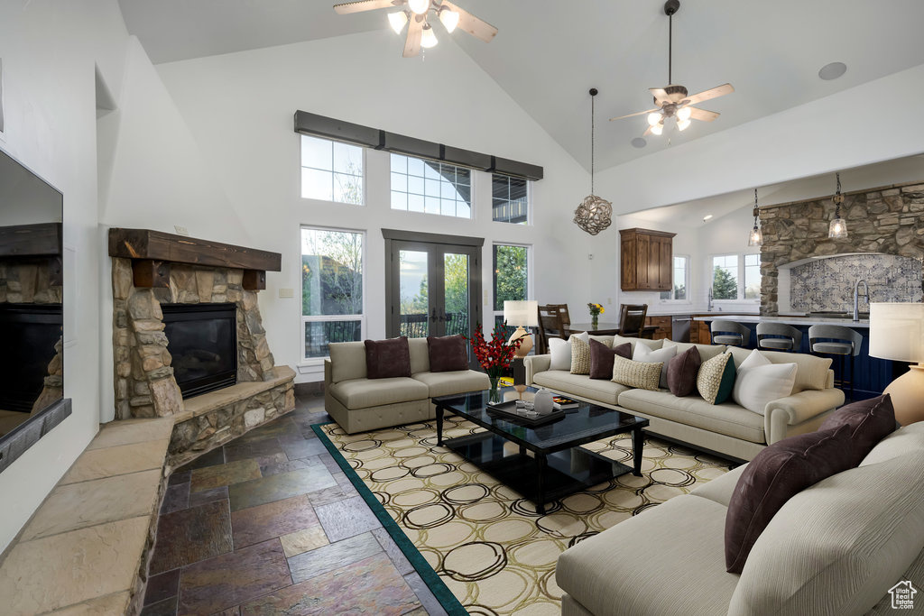 Living room with plenty of natural light, ceiling fan, and a fireplace