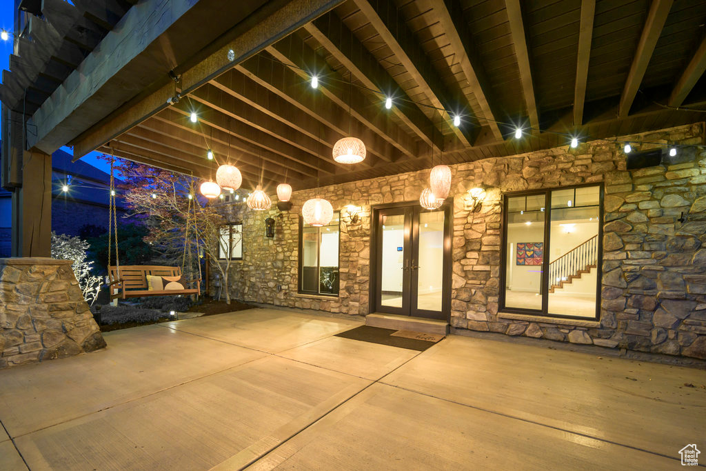 Patio terrace at twilight featuring french doors