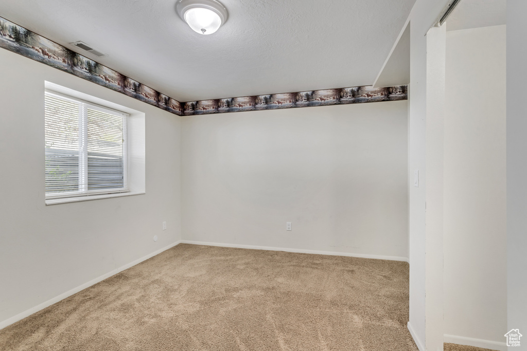 Unfurnished room featuring carpet