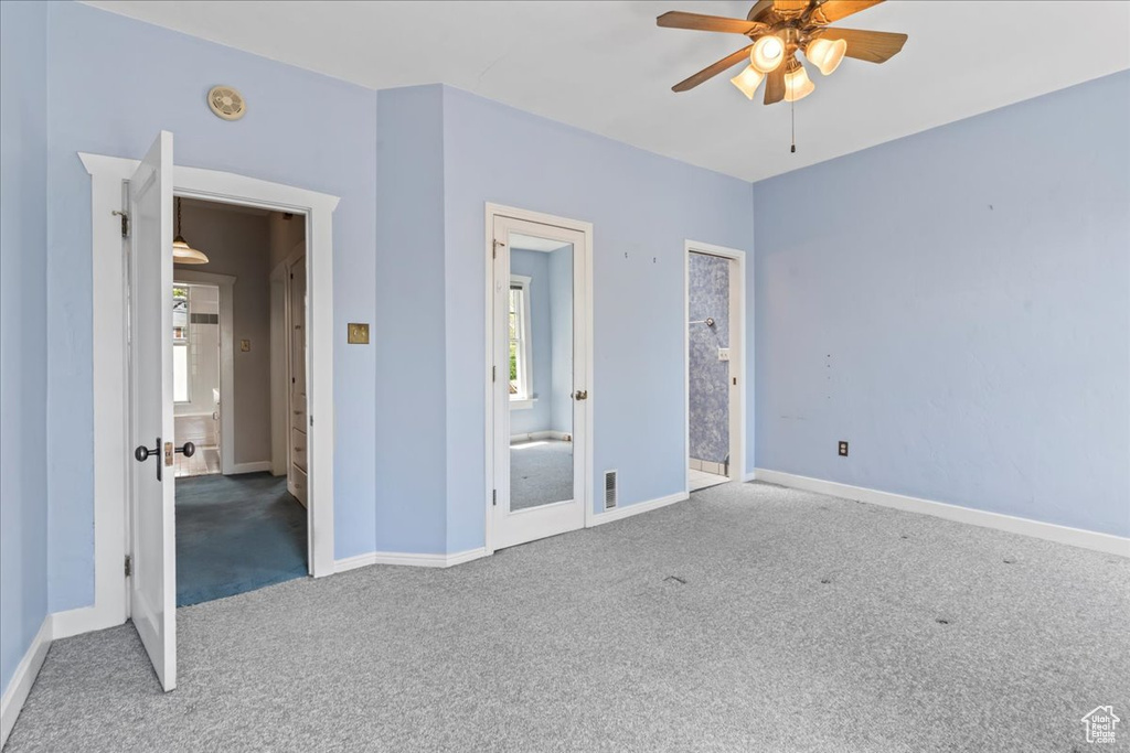Unfurnished bedroom with ceiling fan and carpet floors