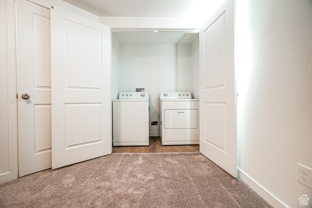 Laundry room featuring carpet flooring and washing machine and clothes dryer