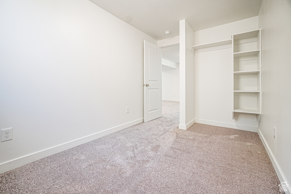 Unfurnished bedroom with carpet flooring and a closet