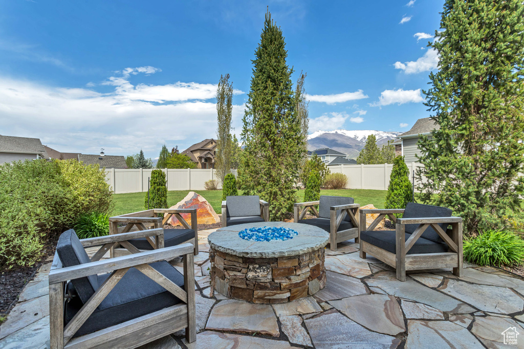View of patio / terrace with a fire pit and a mountain view