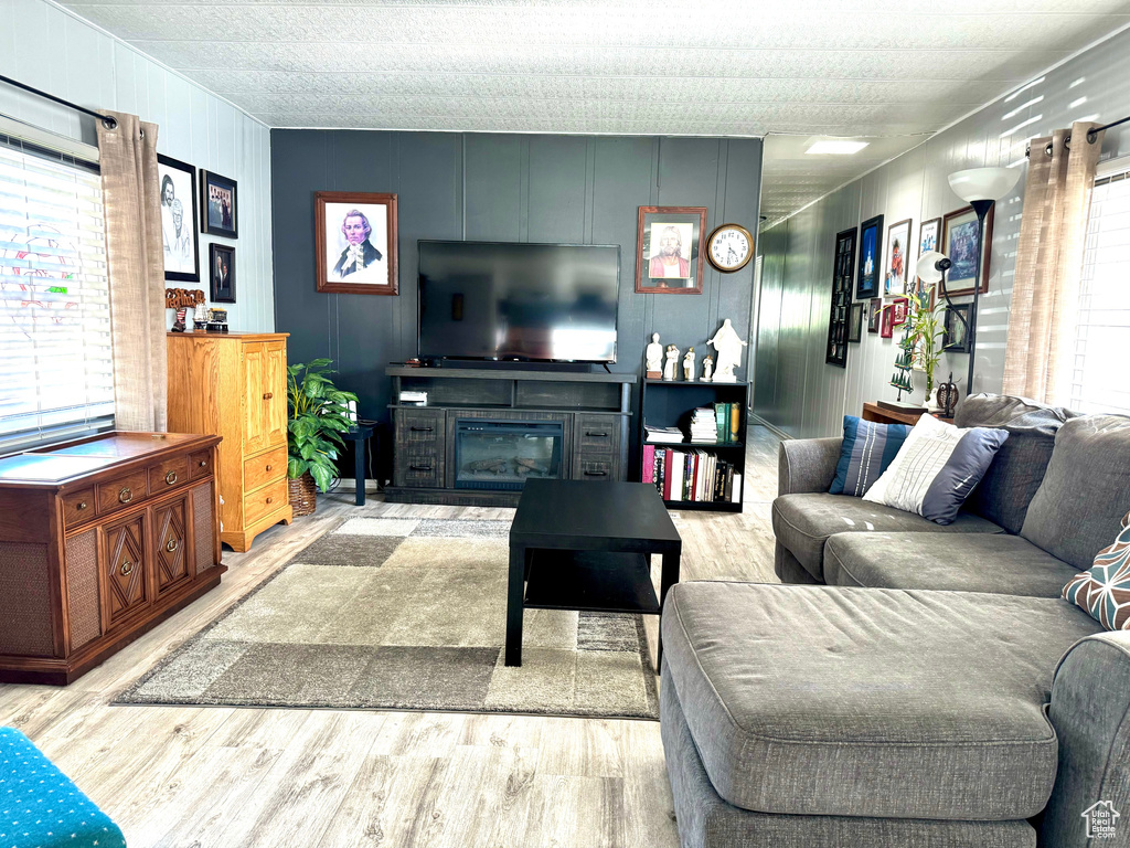 Living room with a textured ceiling and hardwood / wood-style floors