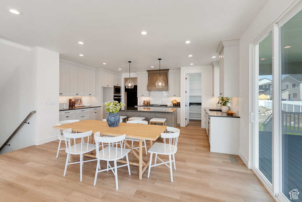 Dining room with a wealth of natural light and light wood-type flooring