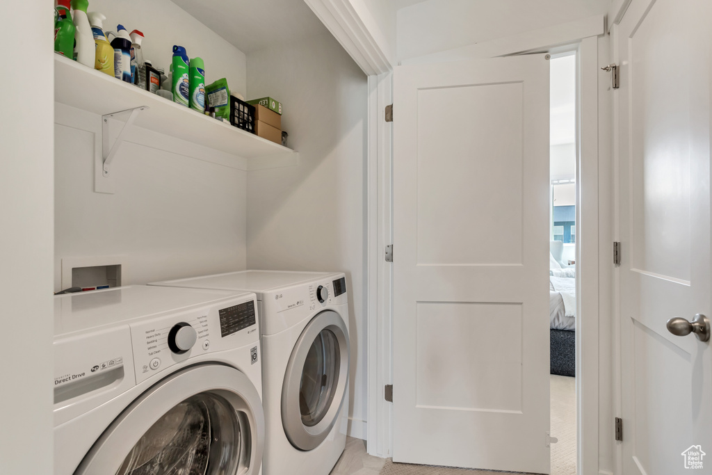 Clothes washing area with independent washer and dryer and light tile floors