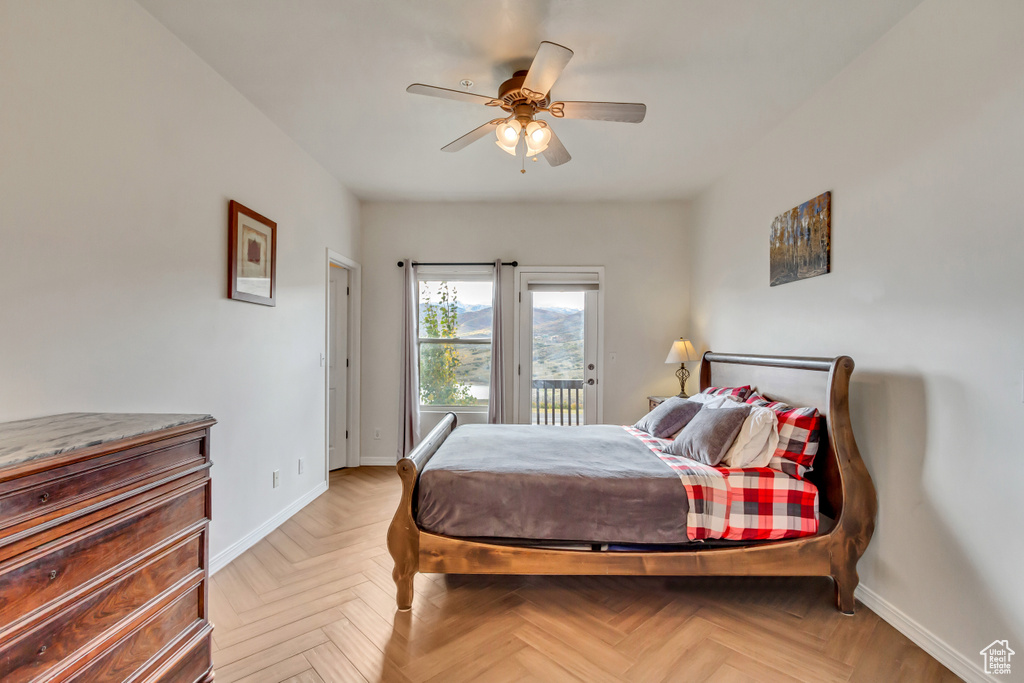 Bedroom with access to exterior, ceiling fan, and parquet floors
