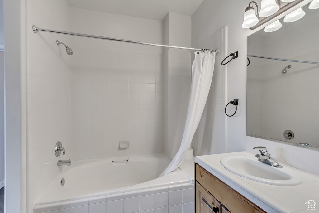 Bathroom with vanity and shower / tub combo with curtain