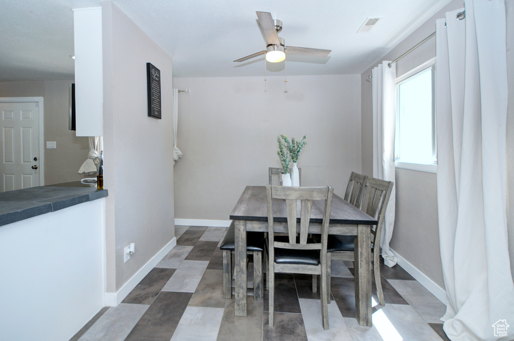 Dining space featuring tile floors and ceiling fan