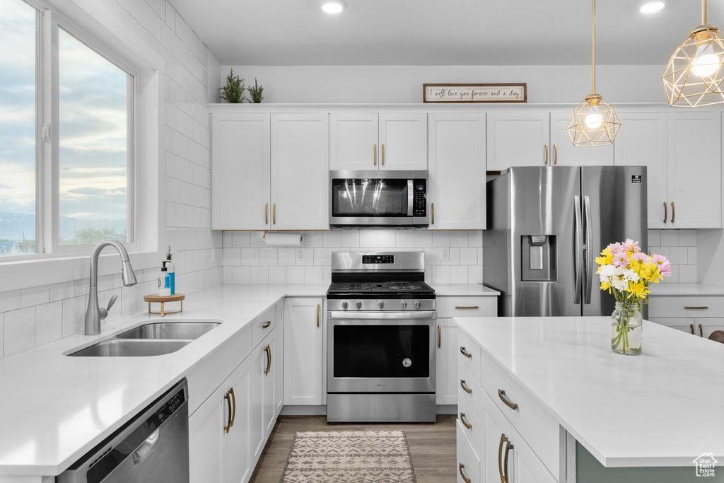 Kitchen with plenty of natural light, tasteful backsplash, and stainless steel appliances