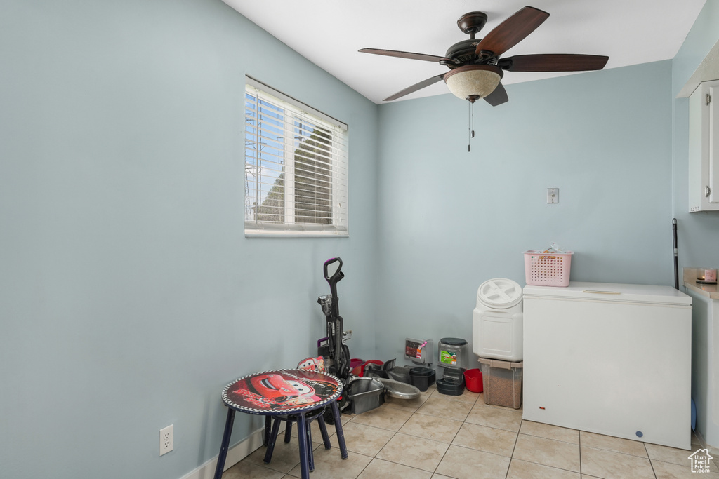 Washroom with ceiling fan and light tile floors