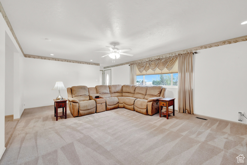 Living room with ceiling fan and carpet