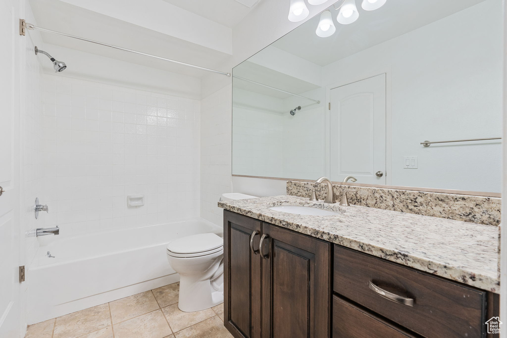 Full bathroom featuring shower / bath combination, tile floors, toilet, and oversized vanity