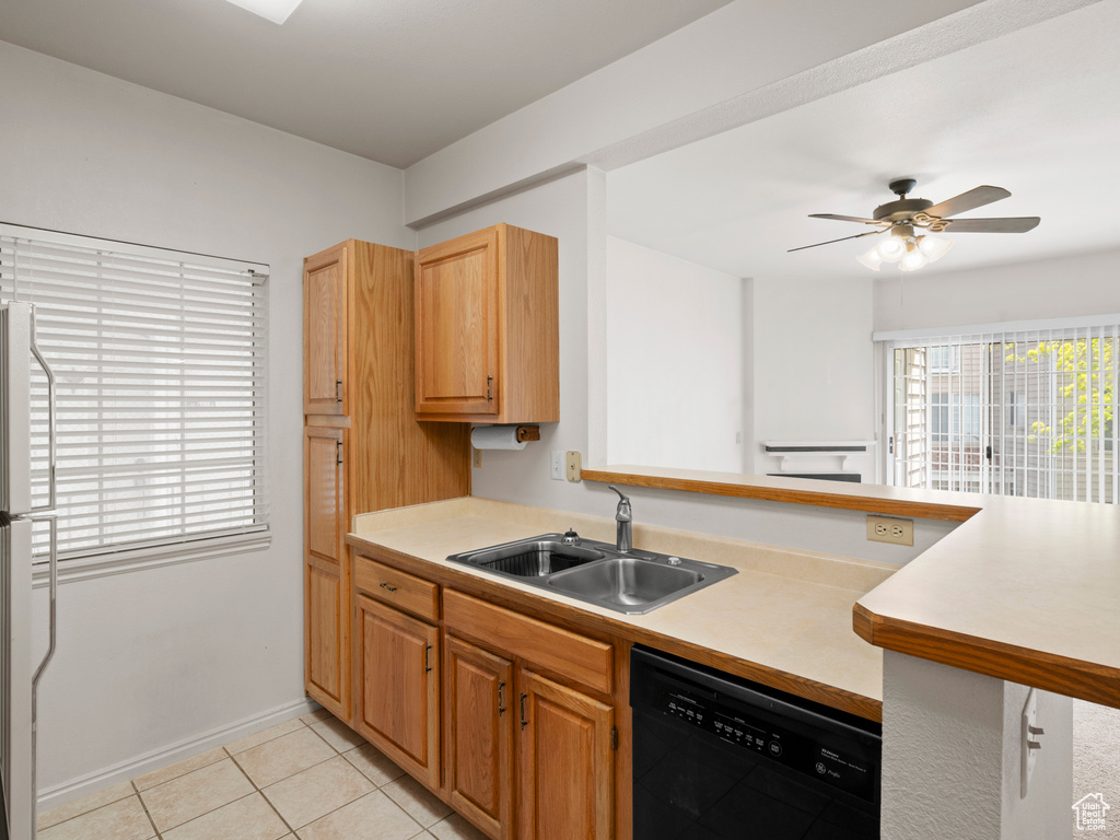 Kitchen with white fridge, ceiling fan, dishwasher, sink, and light tile floors