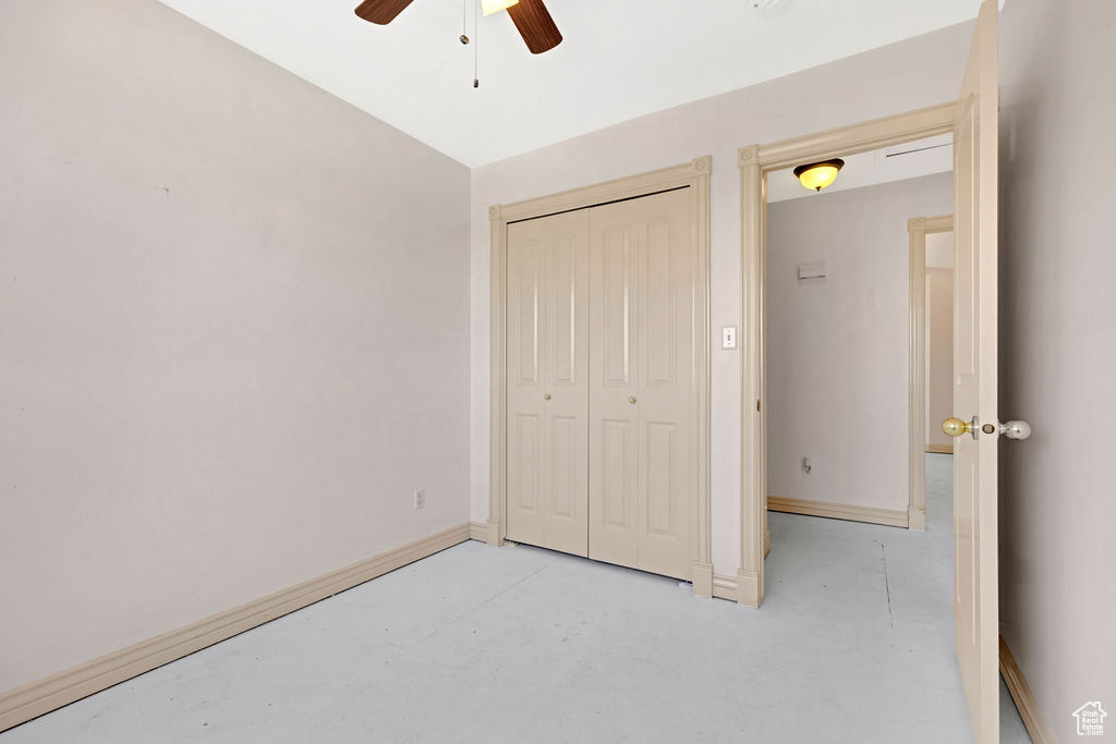Unfurnished bedroom with a closet and ceiling fan