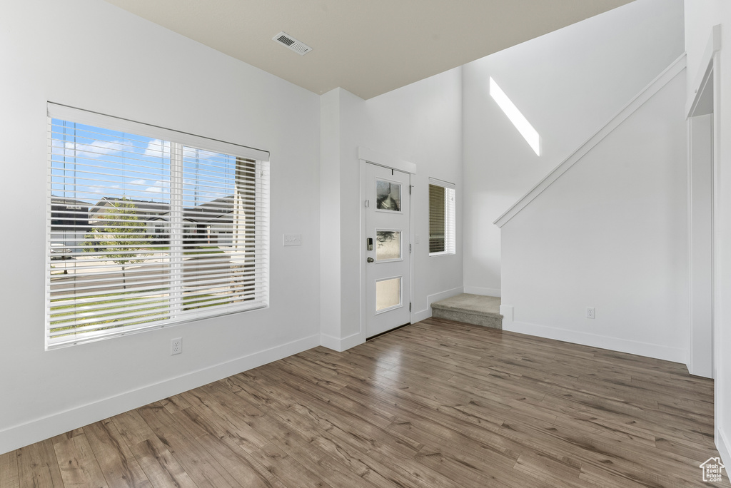 Entryway with plenty of natural light and hardwood / wood-style floors