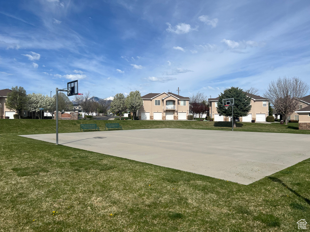View of basketball court featuring a yard