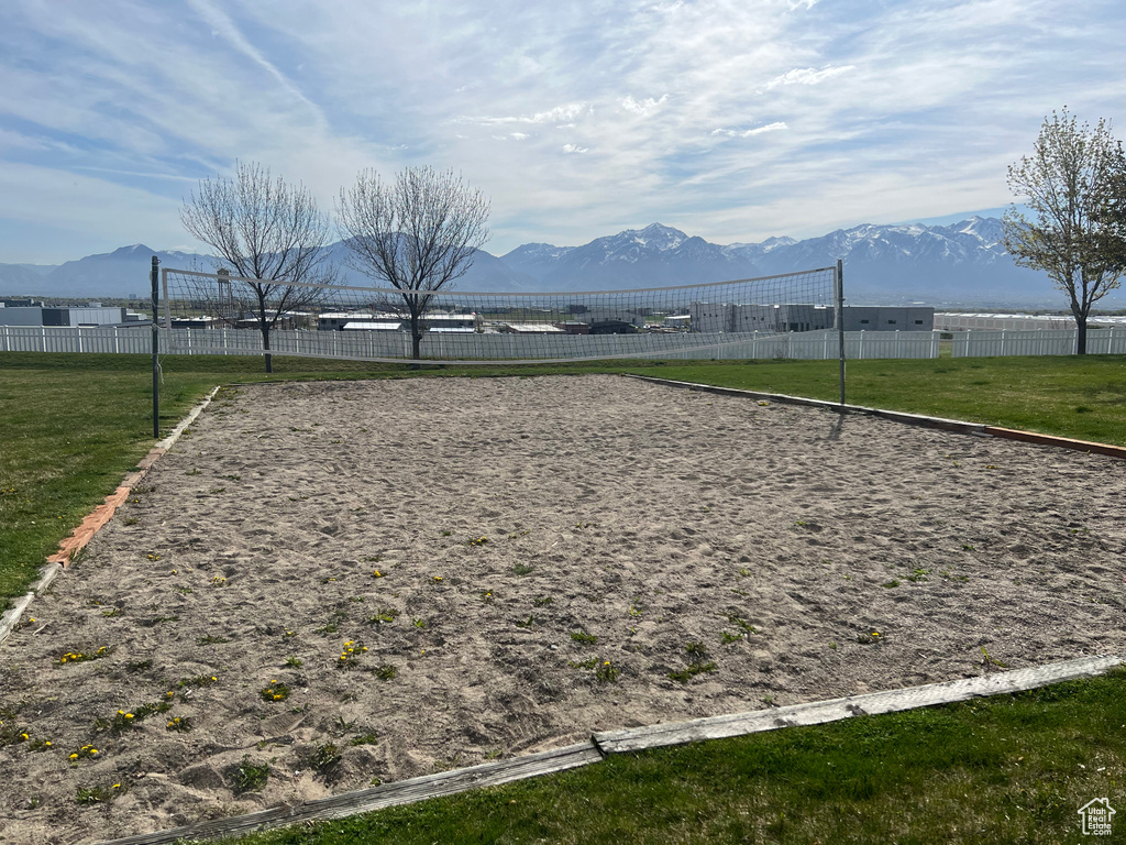 Surrounding community featuring a mountain view, volleyball court, and a lawn