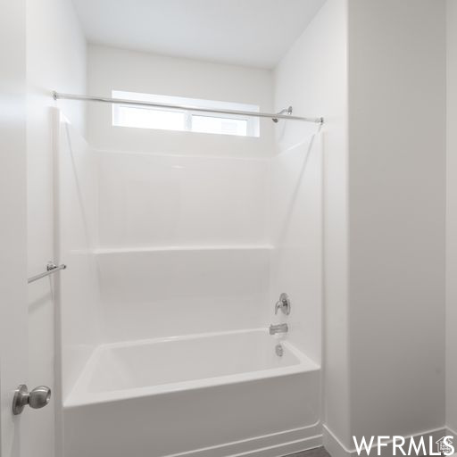 Bathroom with plenty of natural light and bathtub / shower combination