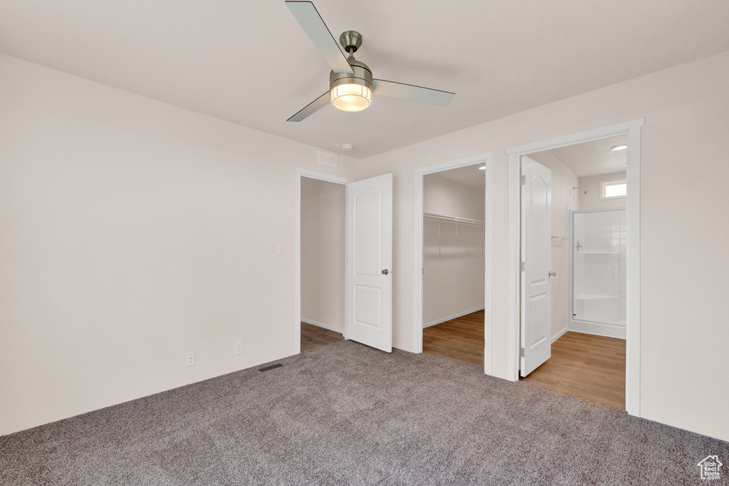 Unfurnished bedroom with a closet, carpet floors, and ceiling fan