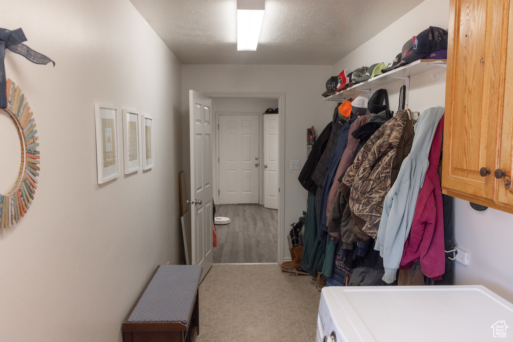 Mudroom with carpet floors and washer / clothes dryer