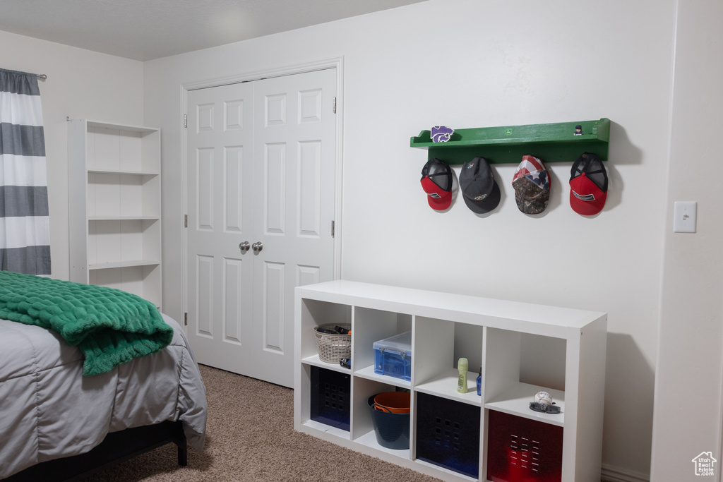 Bedroom with carpet and a closet
