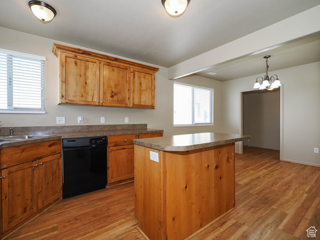 Kitchen featuring light hardwood / wood-style floors, dishwasher, a center island, and sink
